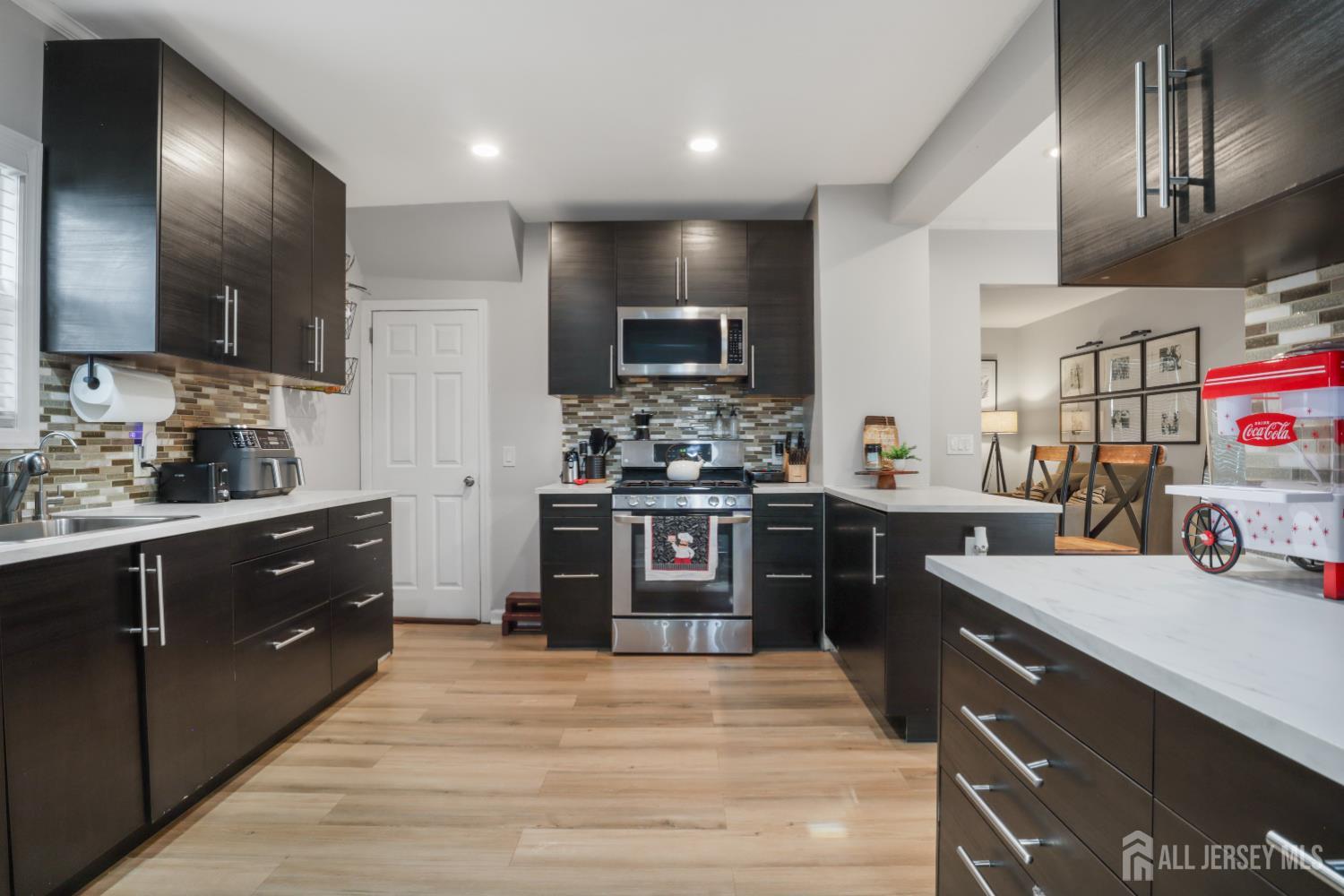 59 South 2nd Street Fords, NJ 08863 - Photo 12 of 37 a large kitchen with stainless steel appliances wooden cabinets and a stove top oven