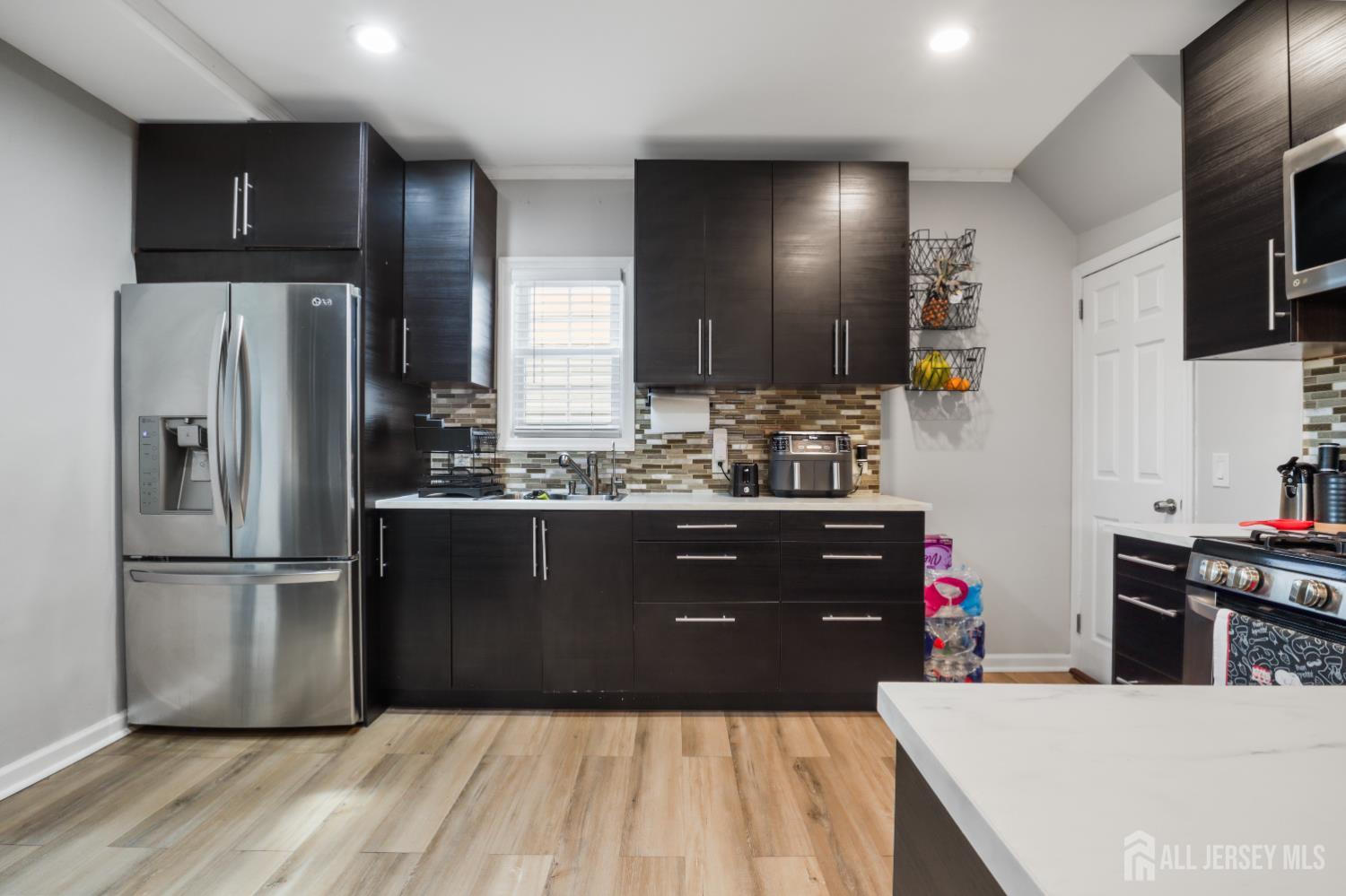 59 South 2nd Street Fords, NJ 08863 - Photo 13 of 37 a kitchen with a refrigerator and a sink