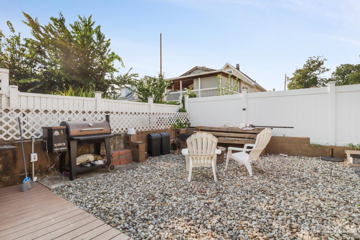 59 South 2nd Street Fords, NJ 08863 - Photo 31 of 37 a view of a roof deck with table and chairs with wooden fence