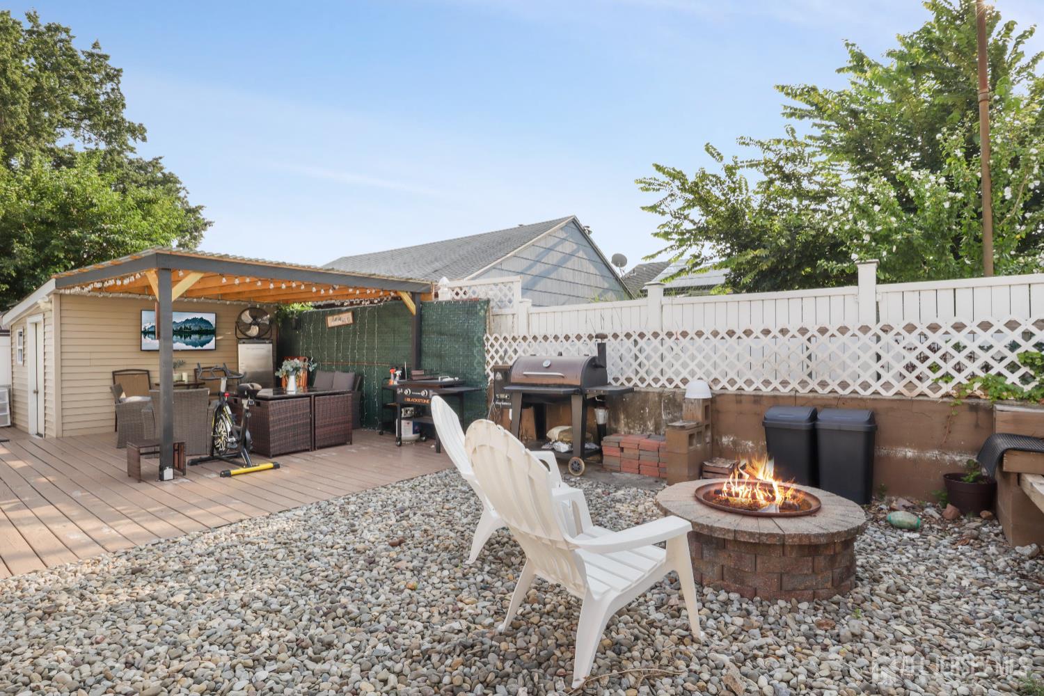 59 South 2nd Street Fords, NJ 08863 - Photo 32 of 37 a view of a patio with a table chairs and a fire pit