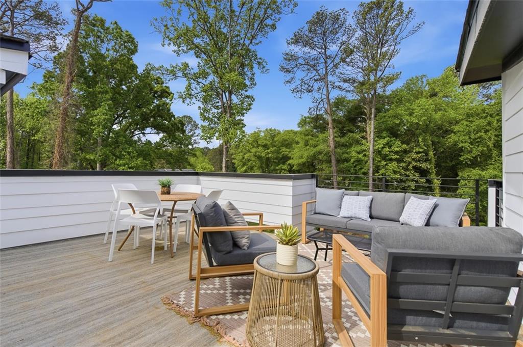 1194 Penny Lane Atlanta, GA 30329 - Photo 35 of 50 a view of a patio with a dining table and chairs with wooden floor