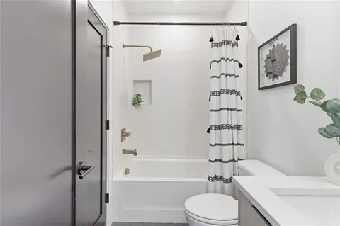 a bathroom with a toilet and a shower