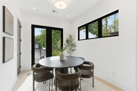 a view of a dining room with furniture window and outside view