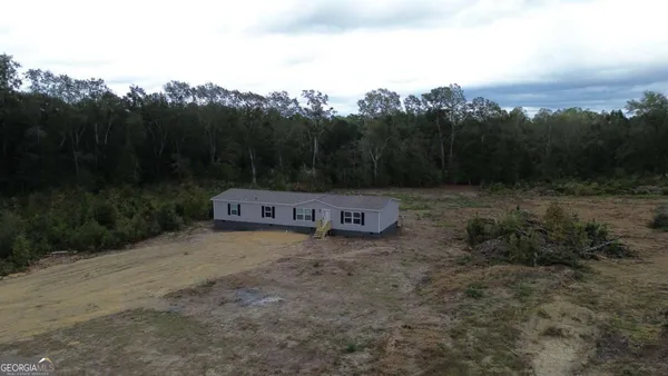 a view of a town with trees in the background