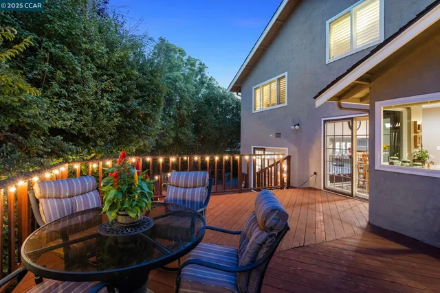 a view of a deck with couches with wooden floor and fence