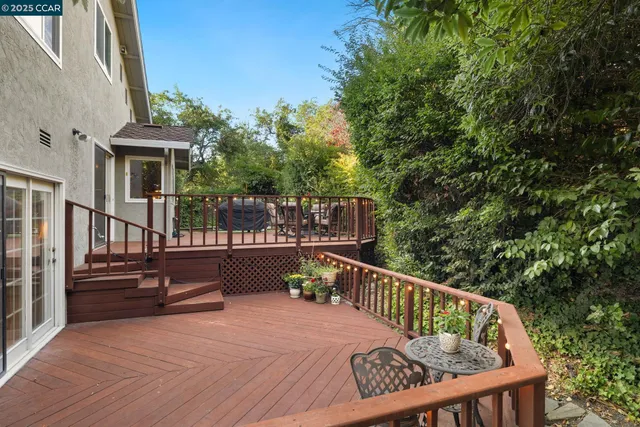 a backyard of a house with table and chairs