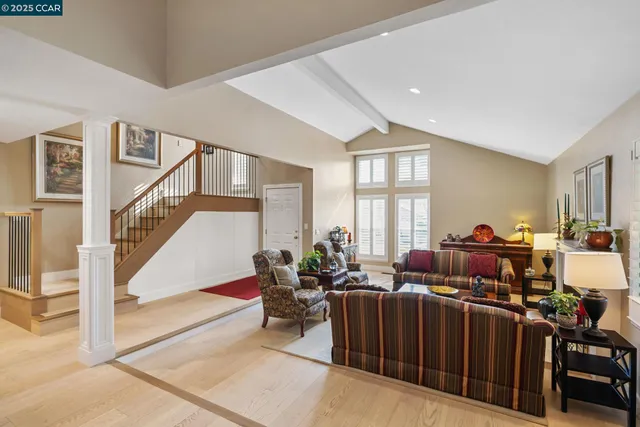 a living room with furniture tv and a window