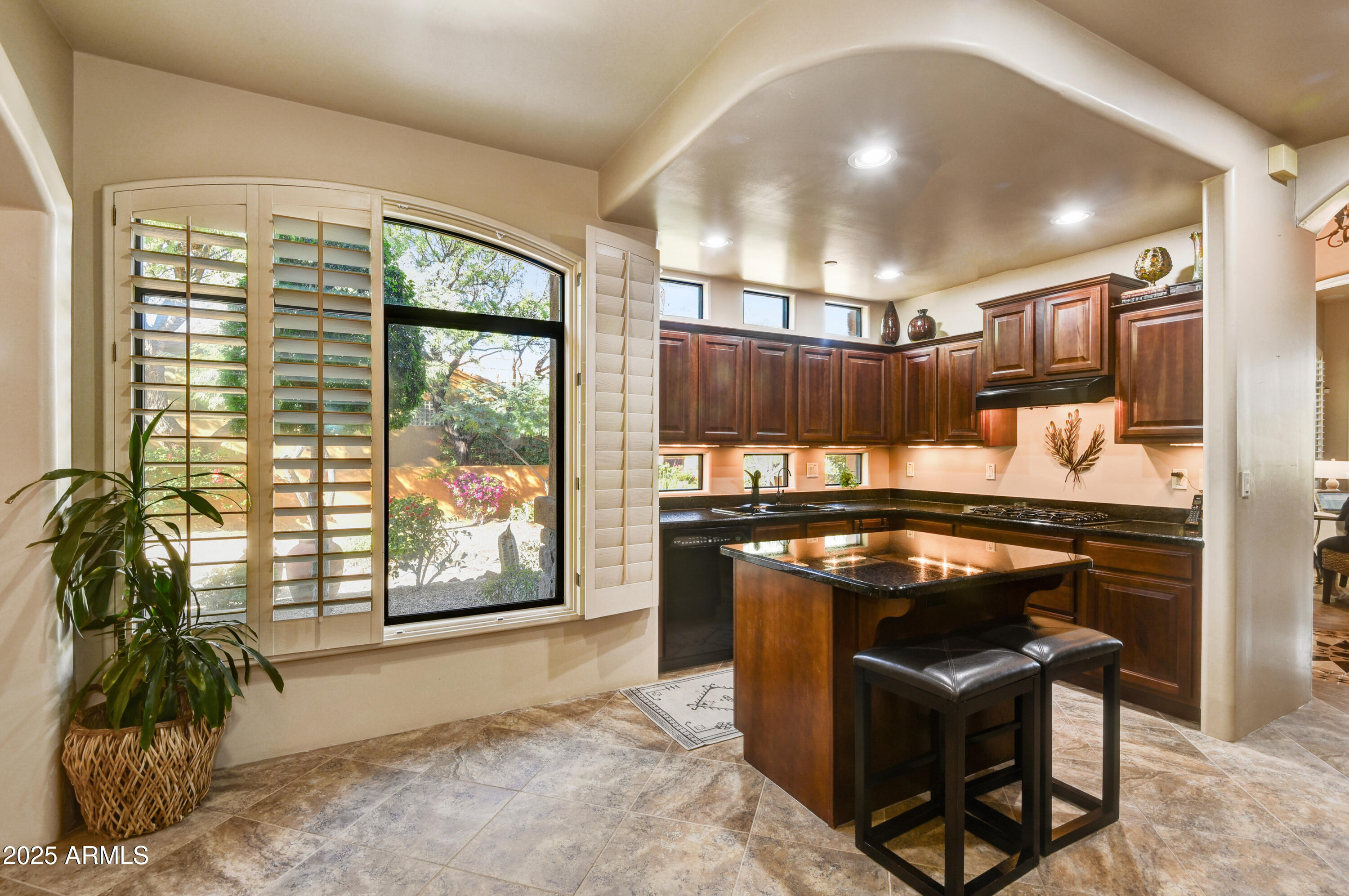 7199 East Ridgeview Place, Unit 100 Carefree, AZ 85377 - Photo 12 of 25 a kitchen with stainless steel appliances granite countertop a stove and a refrigerator