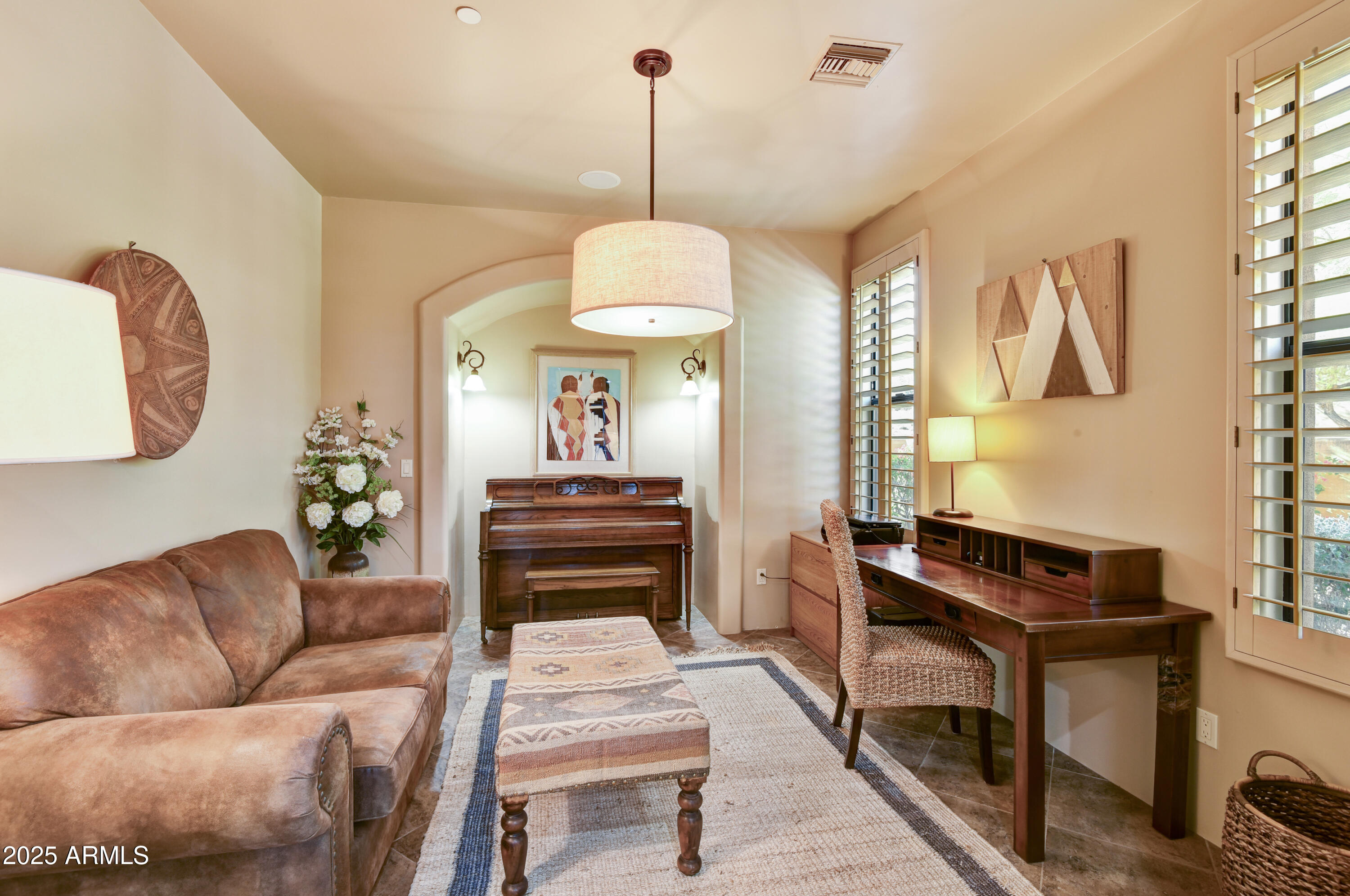 7199 East Ridgeview Place, Unit 100 Carefree, AZ 85377 - Photo 13 of 25 a living room with furniture a piano and a window