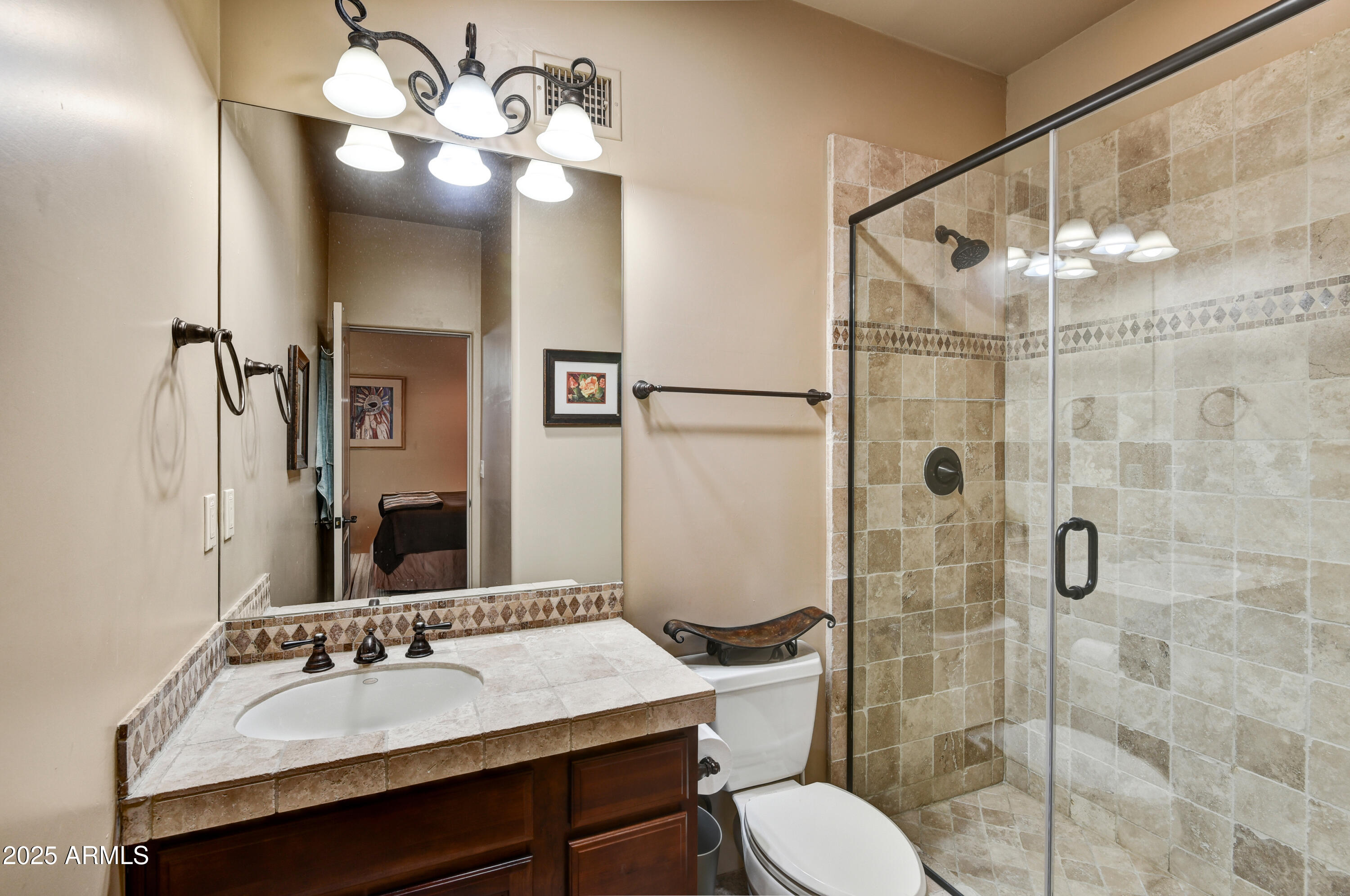 7199 East Ridgeview Place, Unit 100 Carefree, AZ 85377 - Photo 19 of 25 a bathroom with a sink toilet a mirror and shower
