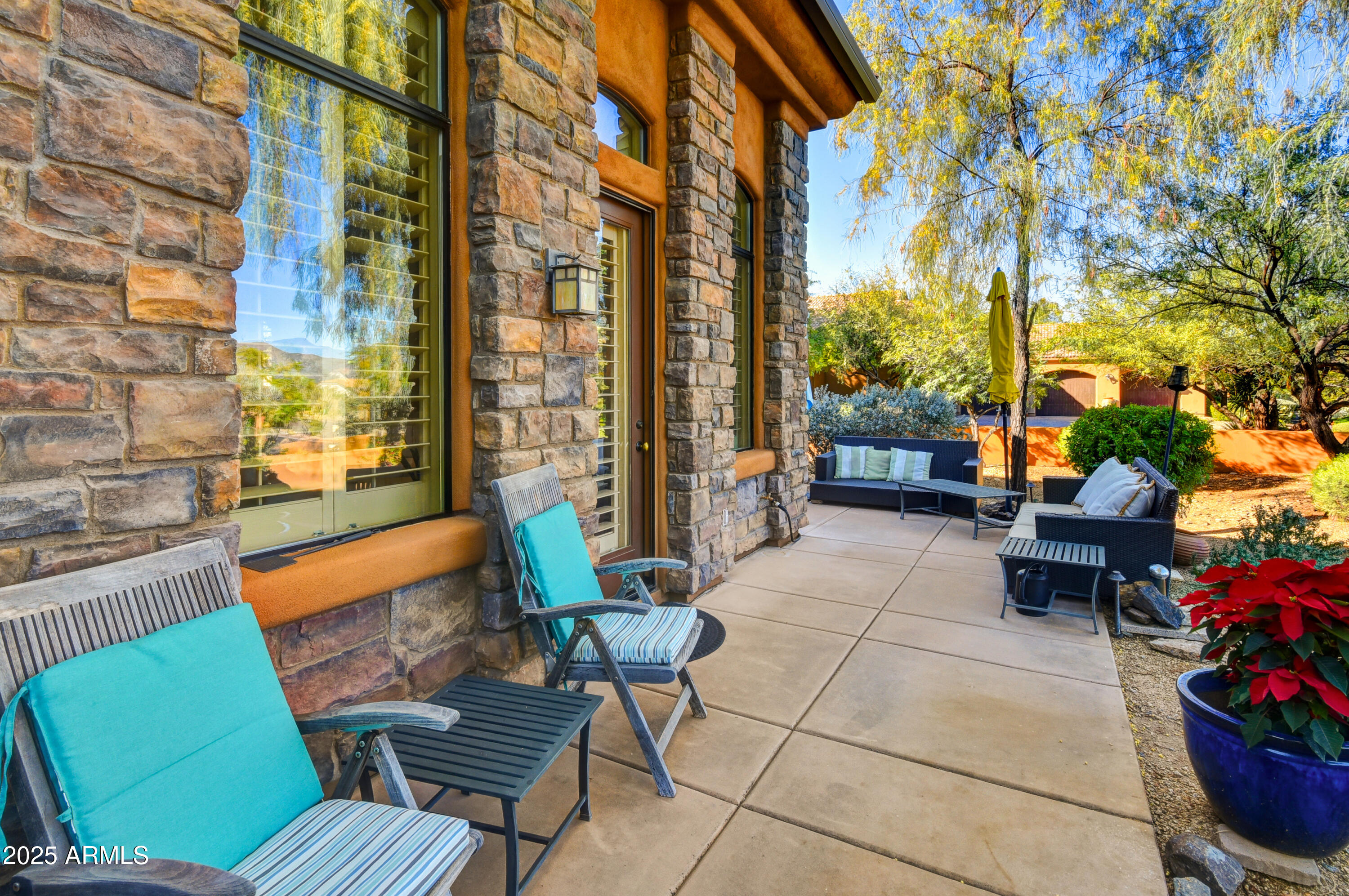7199 East Ridgeview Place, Unit 100 Carefree, AZ 85377 - Photo 24 of 25 a outdoor living space with patio furniture and a potted plant