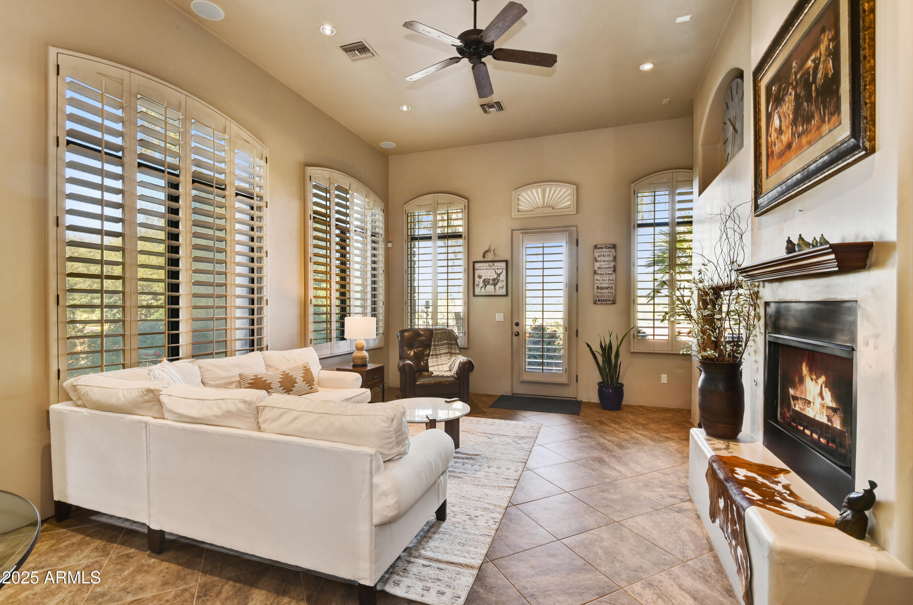 7199 East Ridgeview Place, Unit 100 Carefree, AZ 85377 - Photo 4 of 25 a living room with furniture and a fireplace