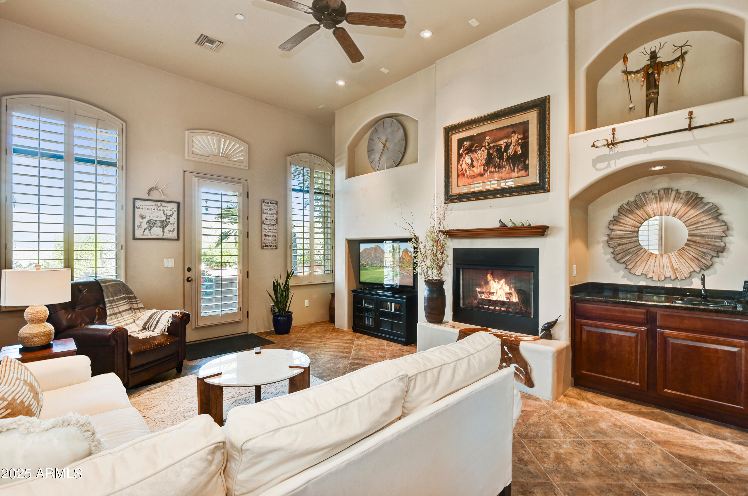 7199 East Ridgeview Place, Unit 100 Carefree, AZ 85377 - Photo 5 of 25 a living room with furniture and a fireplace