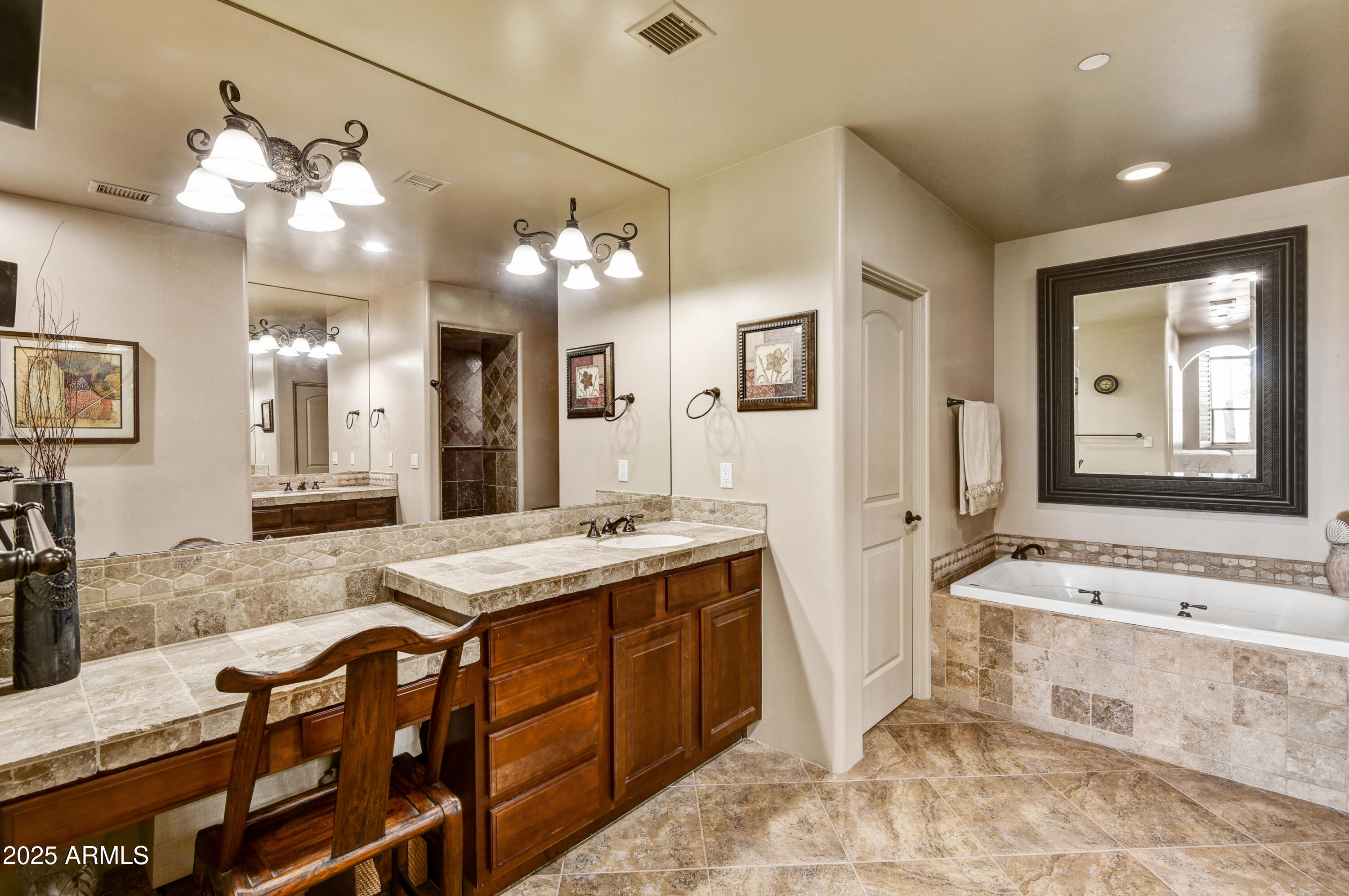 7199 East Ridgeview Place, Unit 100 Carefree, AZ 85377 - Photo 9 of 25 a spacious bathroom with a granite countertop sink a mirror and a bathtub