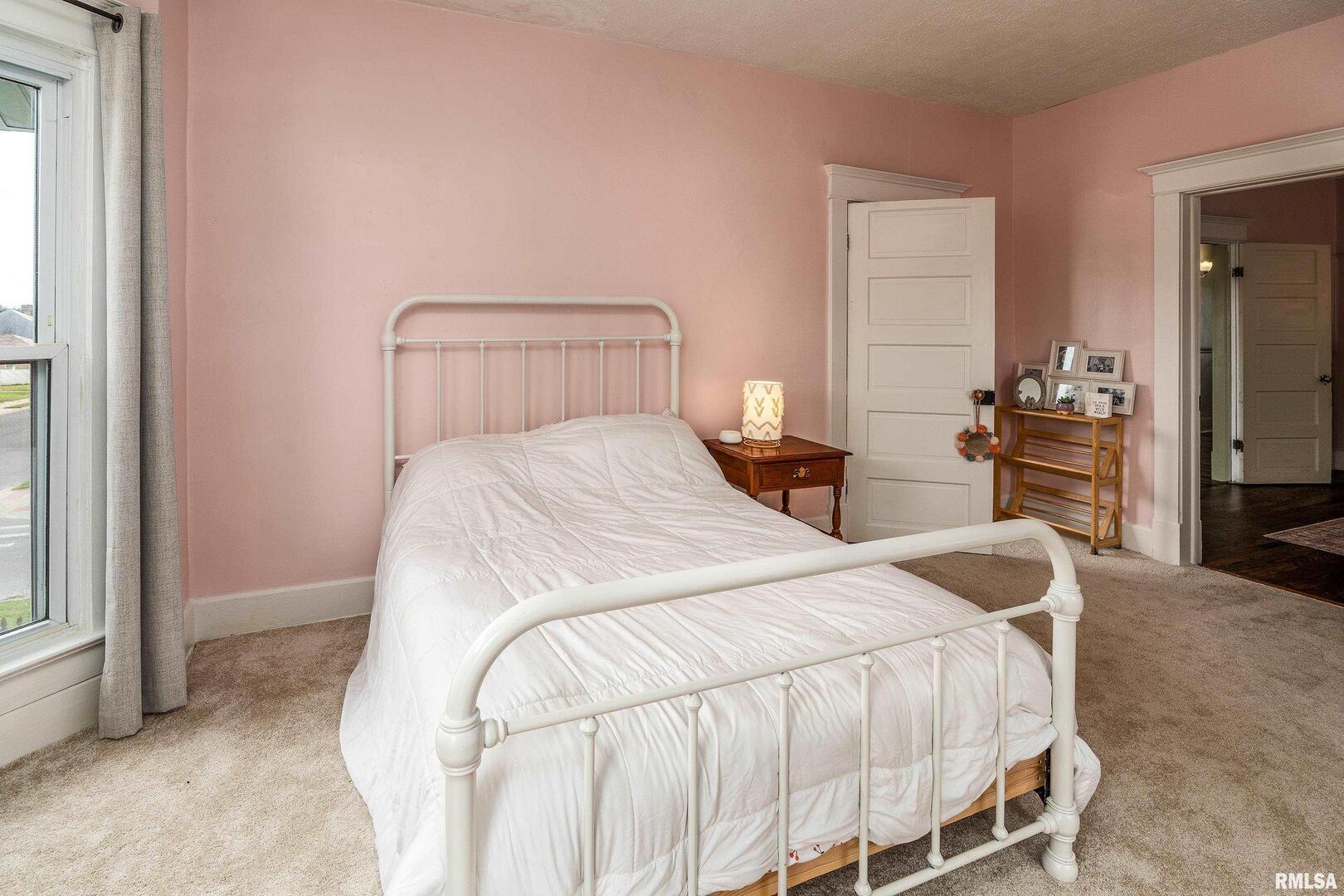 2101 Walnut Street Murphysboro, IL 62966 - Photo 25 of 55 a bedroom with a bed and wooden floor