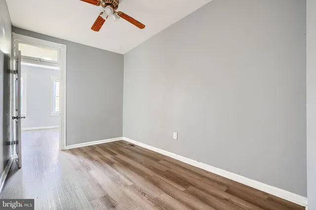 a view of a room with wooden floor