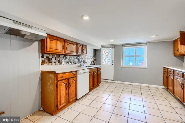 a view of a kitchen with stainless steel appliances granite countertop a refrigerator and cabinets