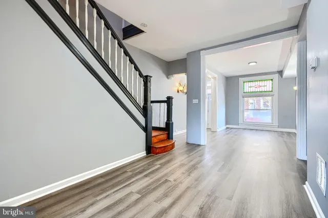 a view of an entryway with wooden floor and stairs