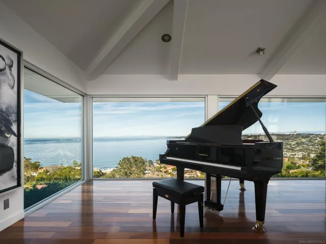 a living room with wooden floor furniture and floor to ceiling window