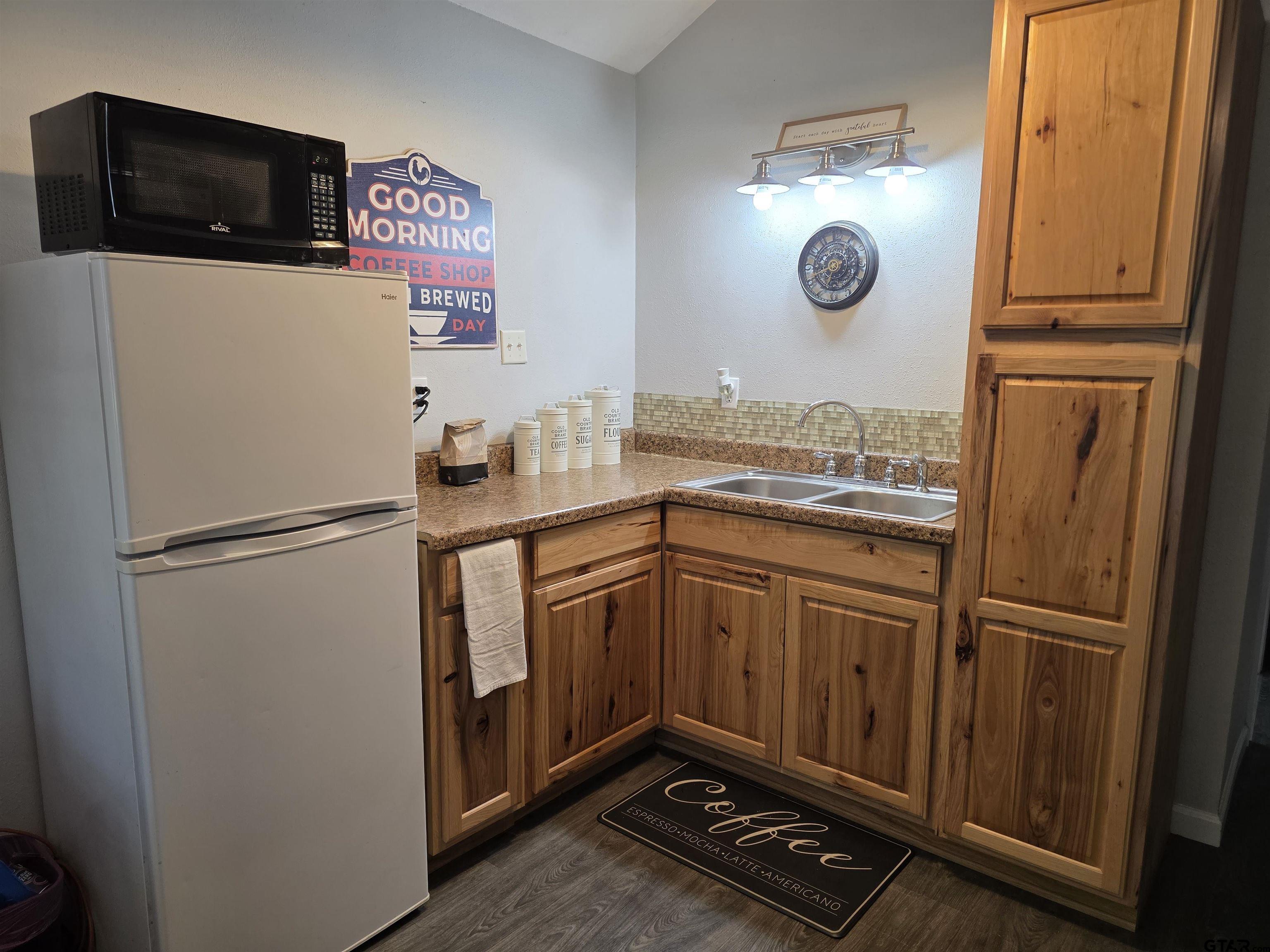 6170 Highway 271 Mount Pleasant, TX 75455 - Photo 40 of 43 a kitchen with stainless steel appliances granite countertop a refrigerator sink and stove