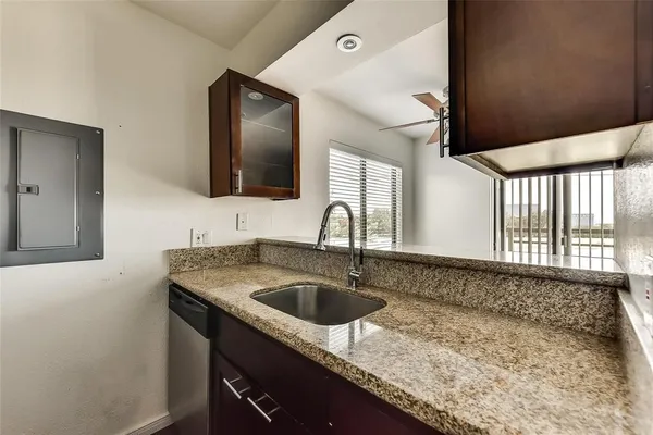 a kitchen with a sink and a stove top oven