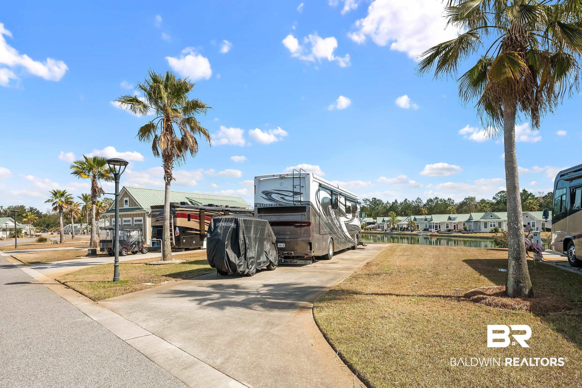 11986 Raptor Court Elberta, AL 36530 - Photo 1 of 28 View of concrete road featuring street lighting and a boat ramp