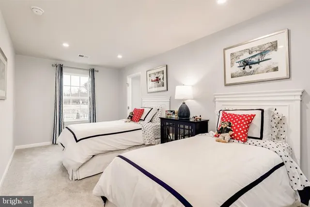 a bedroom with two beds and a window