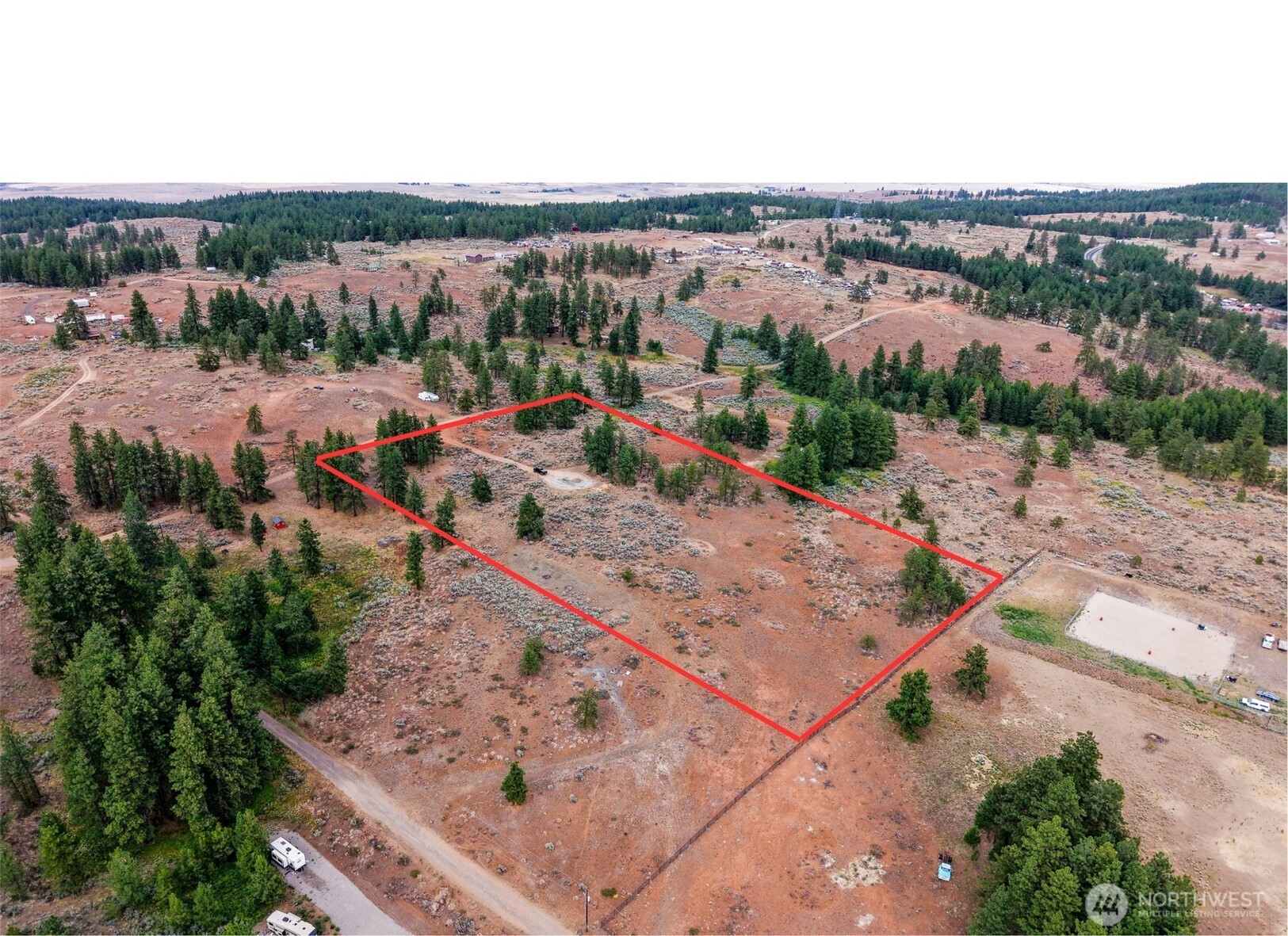 an aerial view of a house with a yard and lake view