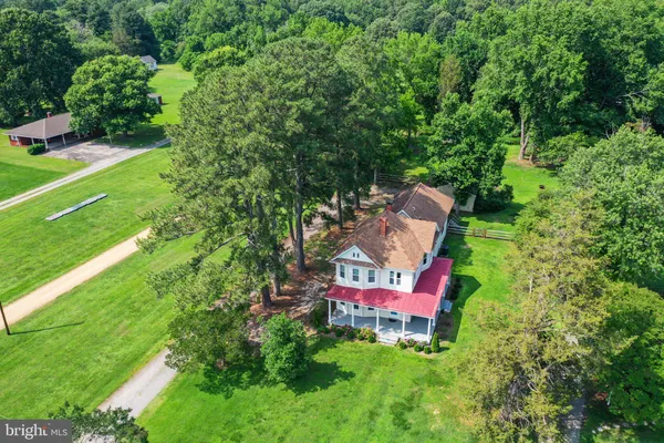 an aerial view of a house with pool yard and outdoor seating