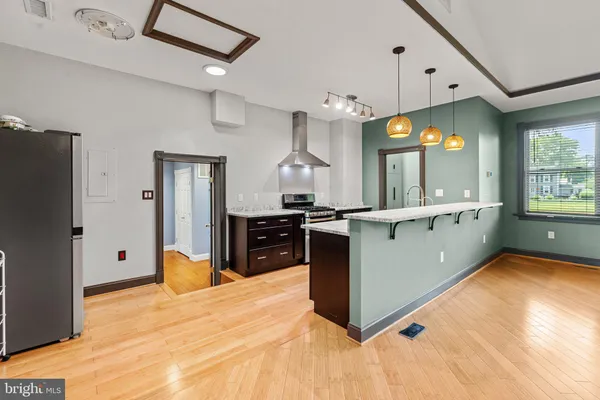 a kitchen with granite countertop a sink cabinets and stainless steel appliances