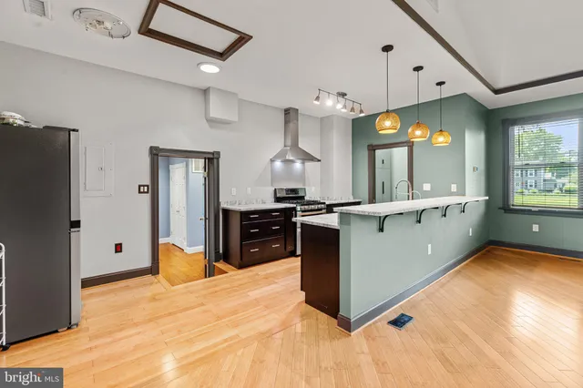 a kitchen with granite countertop a sink cabinets and stainless steel appliances