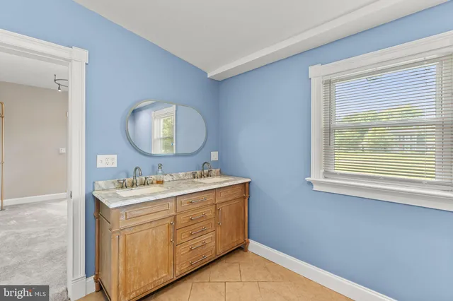 a bathroom with a toilet sink vanity and mirror