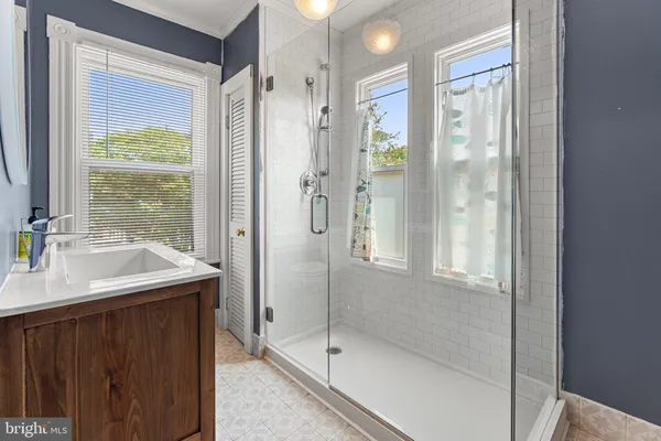 a bathroom with a shower sink and mirror