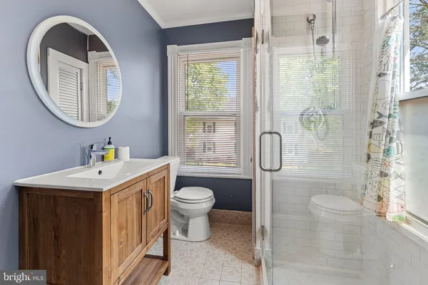 a bathroom with a sink toilet and a mirror