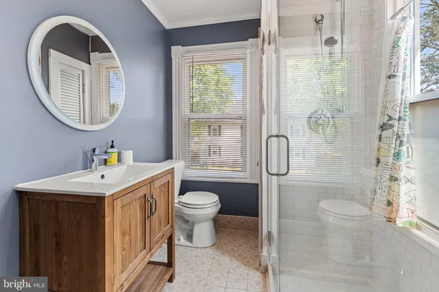 a bathroom with a sink toilet and a mirror