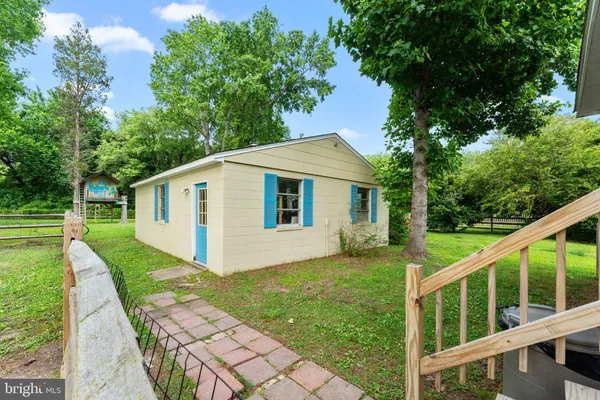 a view of a house with a yard and a garden