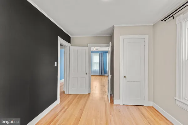 a view of a room with wooden floor and a bathroom