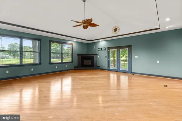 a view of an empty room with window and cabinet