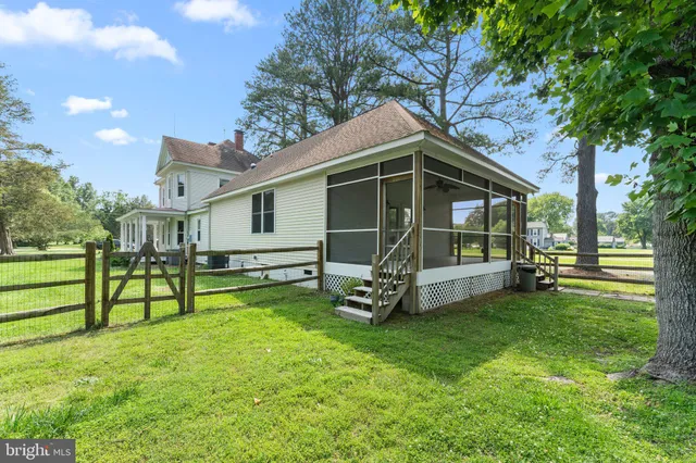 a view of a house with a yard patio and a slide