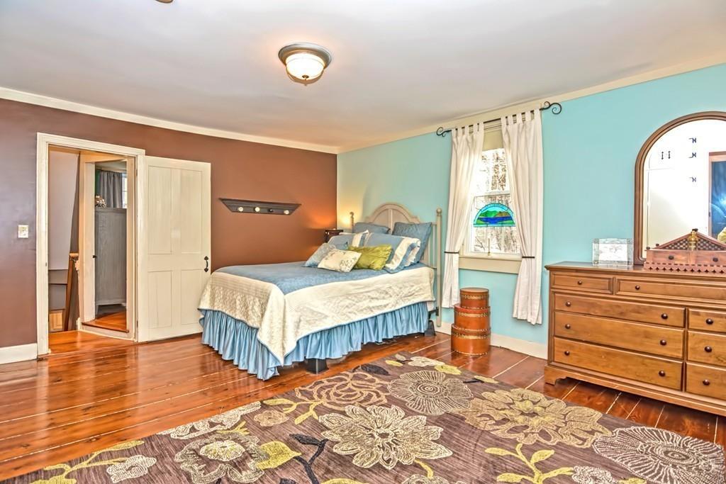 50 Warren Road Brimfield, MA 01010 - Photo 27 of 42 a bedroom with a bed and wooden floor