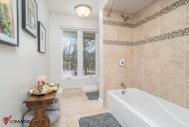 44 Old Creek Road Palos Park, IL 60464 - Photo 17 of 38 a bathroom with a bath tub a mirror and a shower