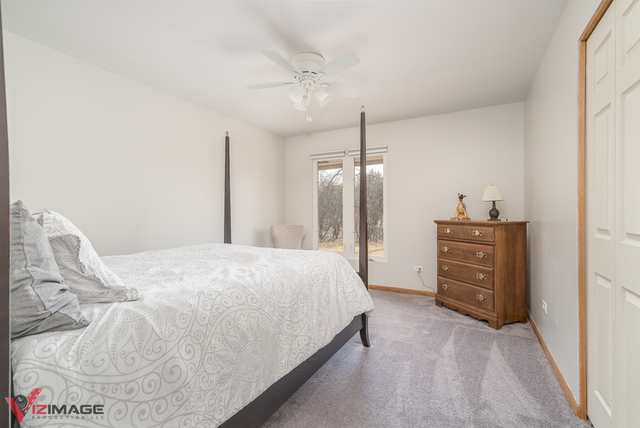 44 Old Creek Road Palos Park, IL 60464 - Photo 19 of 38 a bedroom with a bed and ceiling fan
