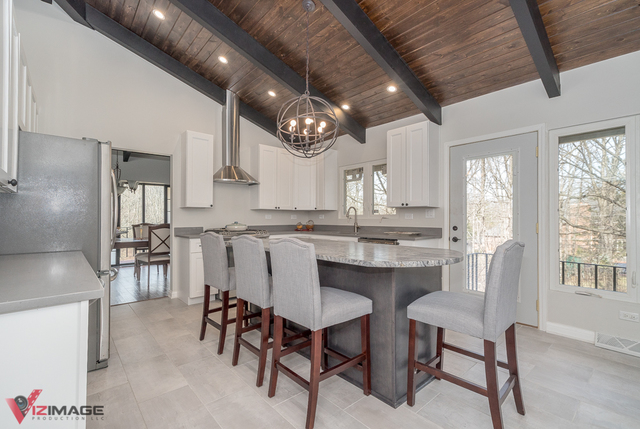44 Old Creek Road Palos Park, IL 60464 - Photo 3 of 38 a kitchen with stainless steel appliances granite countertop a table chairs sink and cabinets