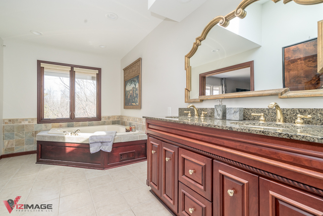 44 Old Creek Road Palos Park, IL 60464 - Photo 24 of 38 a spacious bathroom with a granite countertop tub sink and mirror