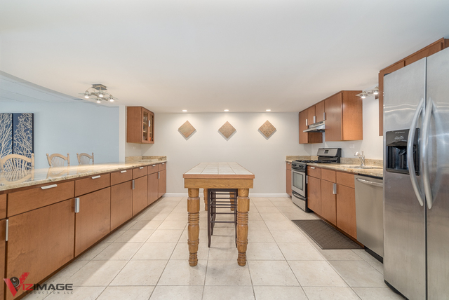44 Old Creek Road Palos Park, IL 60464 - Photo 25 of 38 a kitchen with stainless steel appliances granite countertop a refrigerator sink and cabinets