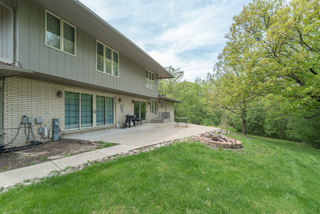 44 Old Creek Road Palos Park, IL 60464 - Photo 32 of 38 a front view of a house with a garden and chairs