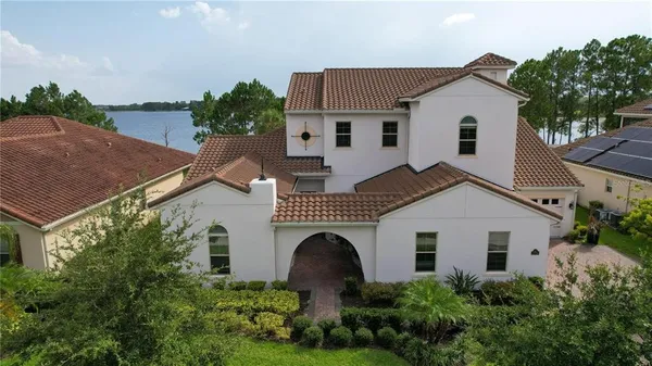 a view of a white house with a yard and plants