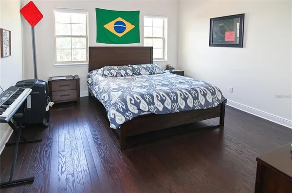 a bedroom with a bed and wooden floor