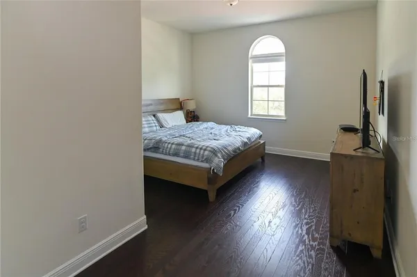 a spacious bedroom with a bed and a window