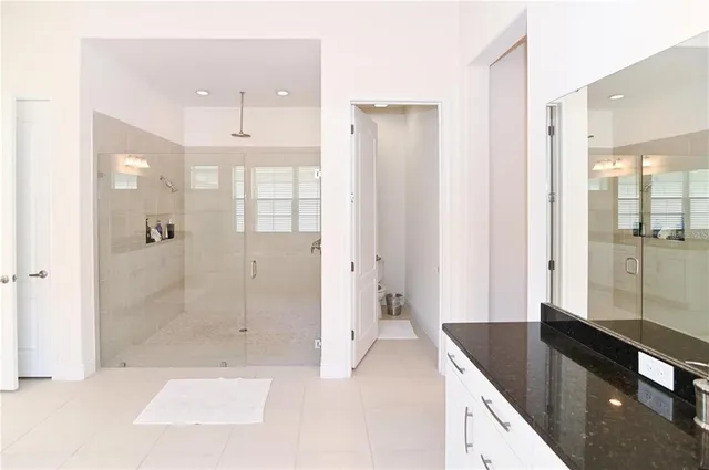 a large white kitchen with cabinets